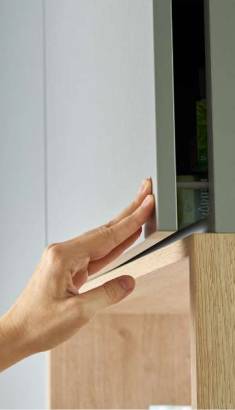 Close-up of modern cabinetry crafted by an Ottawa kitchen cabinet manufacture with a wood grain shelf.